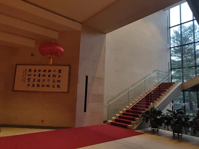 Interior of the Chinese Embassy in Washington, D.C. with a red carpeted staircase.