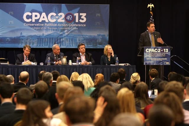 Peter Schiff speaking at a podium during the Conservative Political Action Conference.