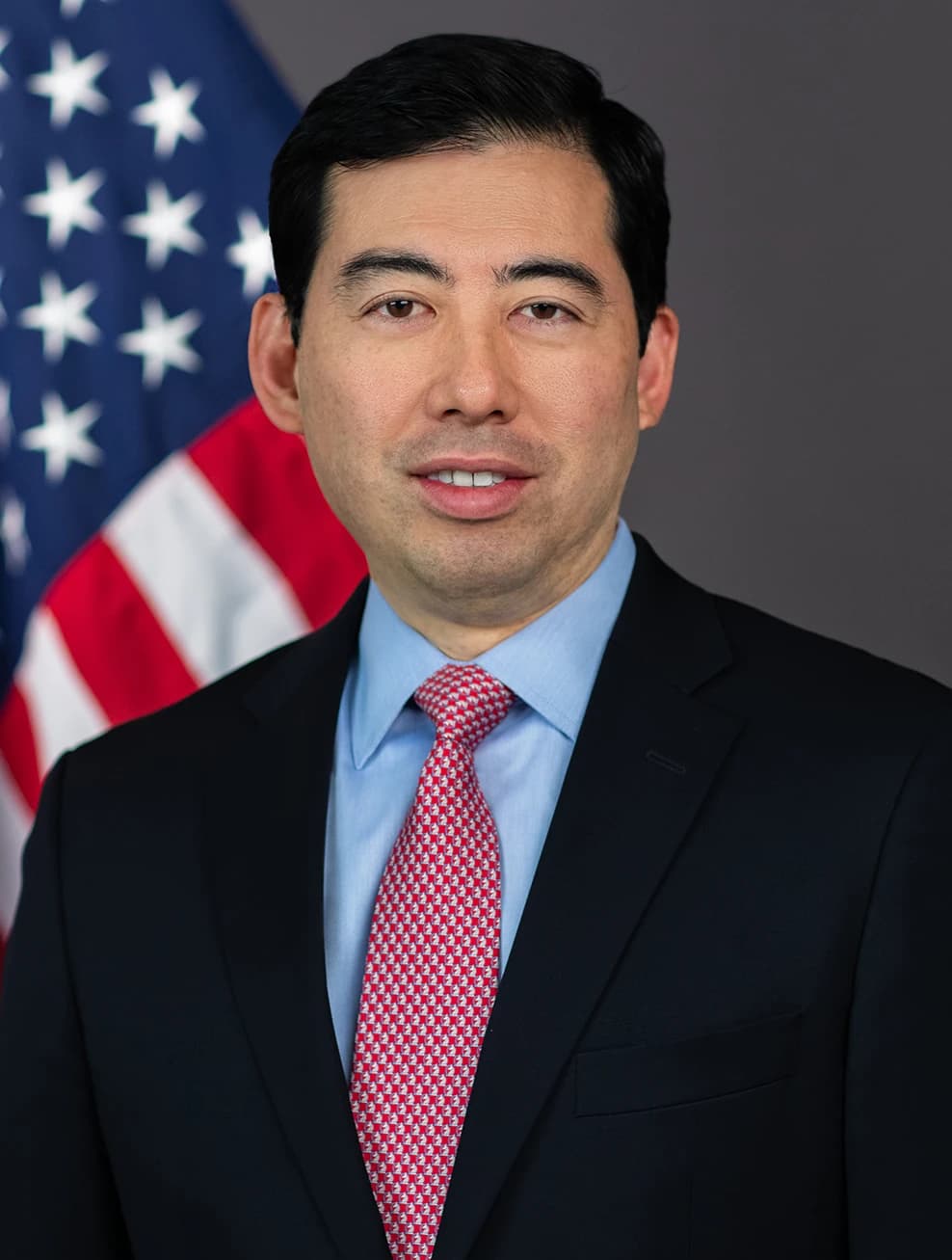 Mark T. Uyeda, SEC Commissioner, poses for official portrait in front of flag.