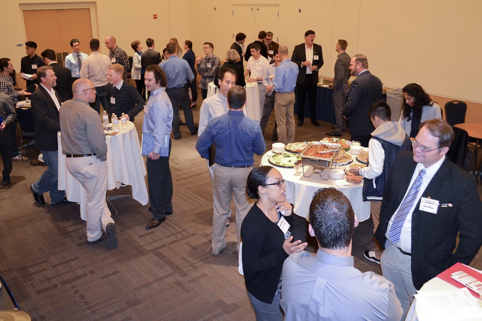 Veterans and students mingle and network at a university job fair event.