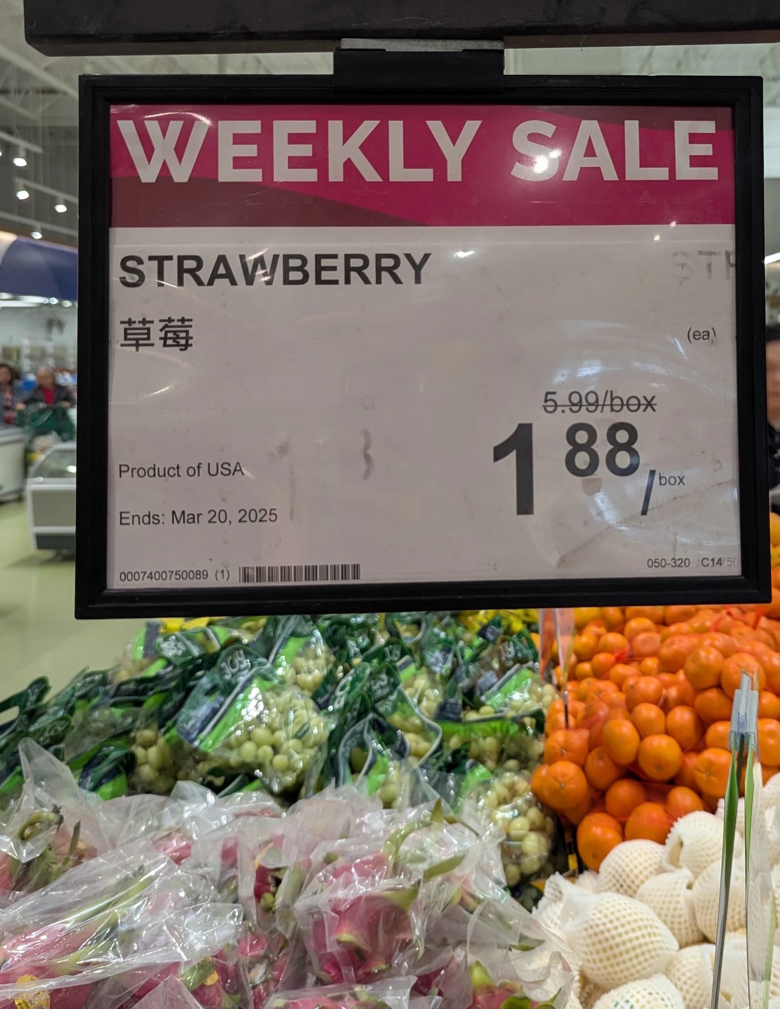 Grocery store sign for 'Product of USA' strawberries priced at $1.88 per box.