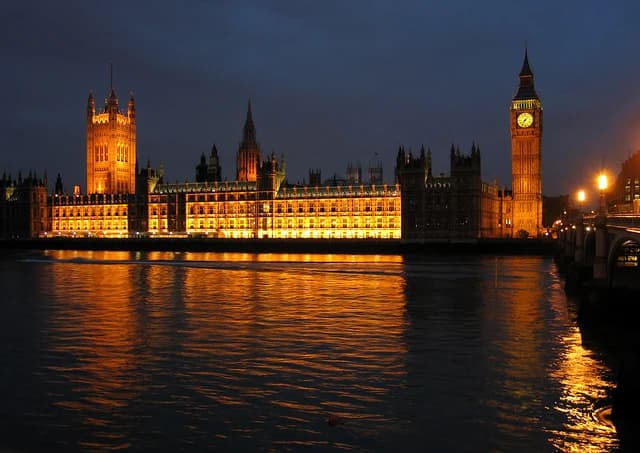 The Palace of Westminster and Elizabeth Tower illuminated at night in London, England.