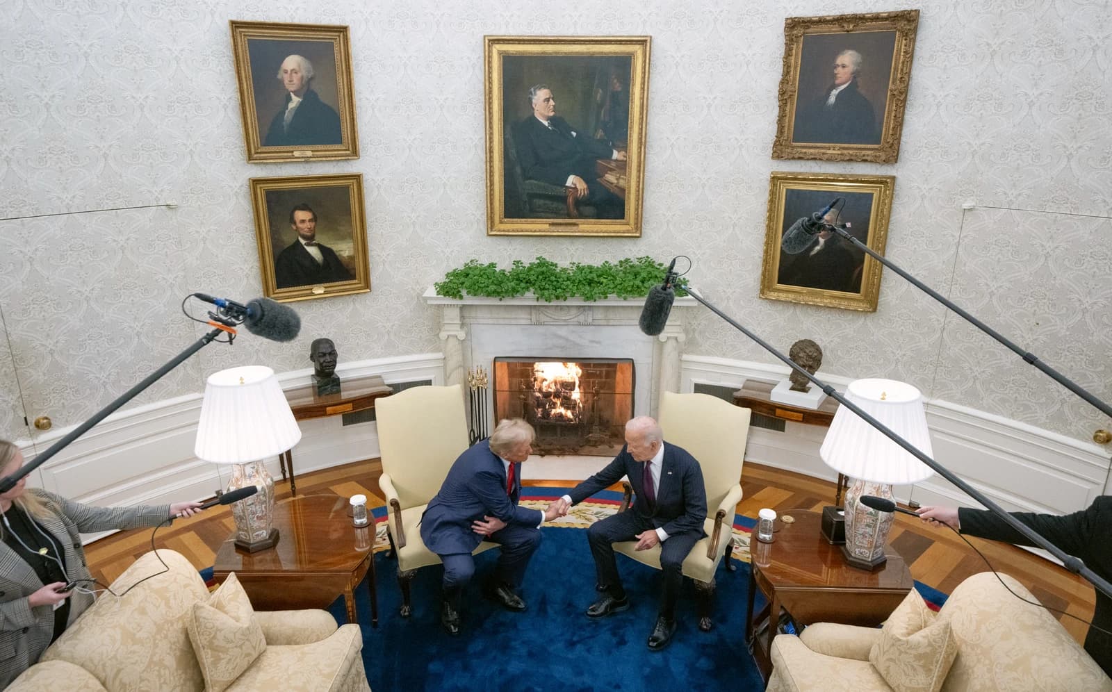 President Joe Biden and president-elect Donald Trump shake hands in the Oval Office.