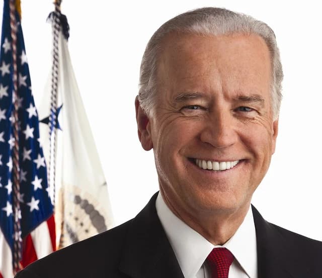 Joe Biden, President of the United States, smiling in an official portrait setting.