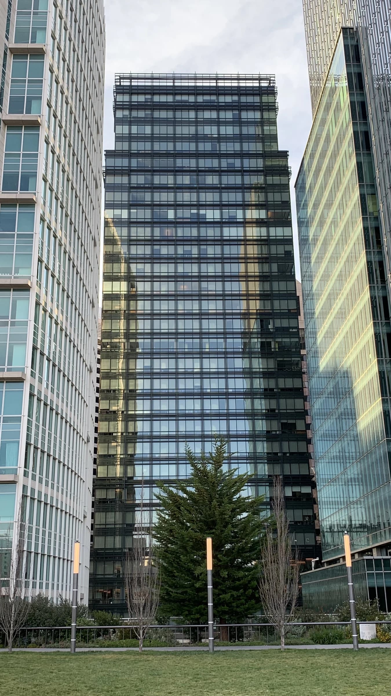 JPMorgan Chase Building, a modern skyscraper with glass facade, viewed from a park.