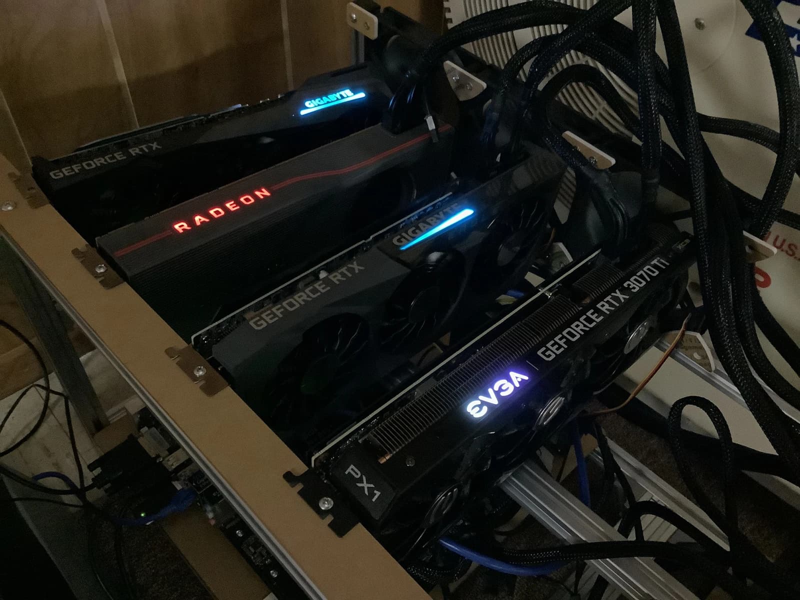Close-up of a cryptocurrency mining rig with multiple graphics cards running.