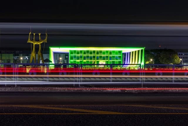 Exterior view of Brazil's Supreme Federal Court building at night with long exposure light streaks.