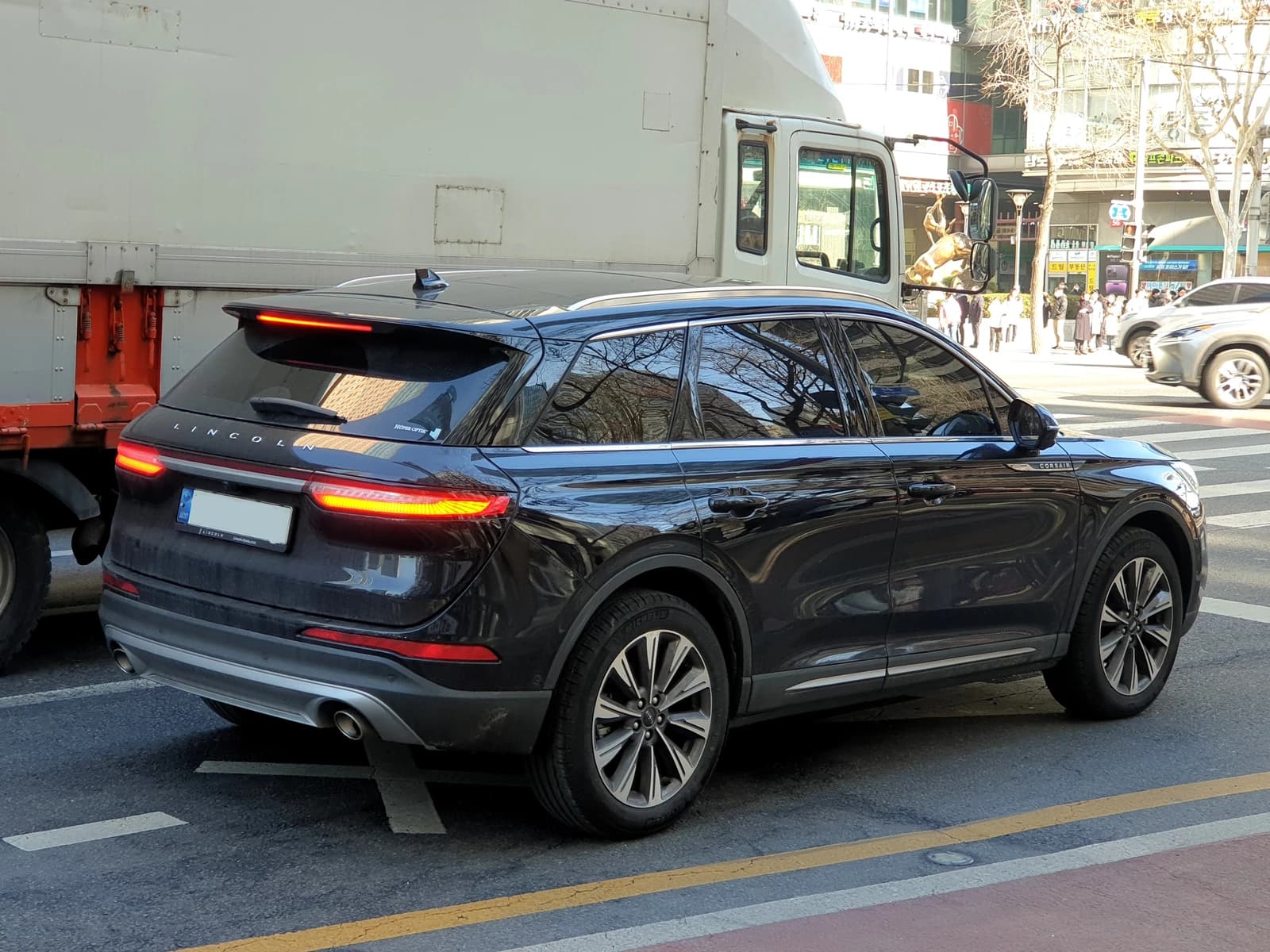 Lincoln Corsair Reserve CX483 Infinite Black SUV on a city street.