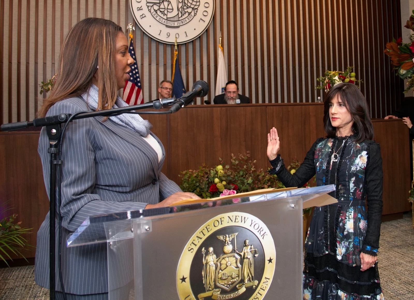 New York Attorney General Letitia James at a podium with a microphone, addressing an audience.