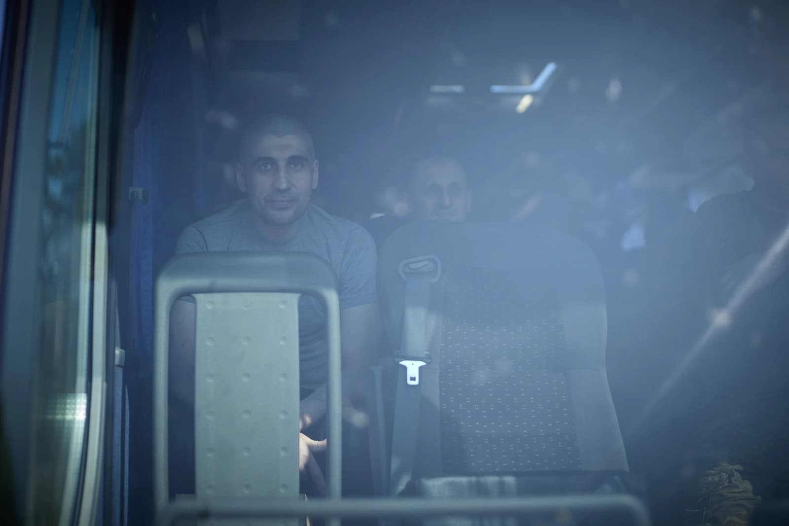 Ukrainian soldiers seen inside a vehicle following a prisoner exchange.