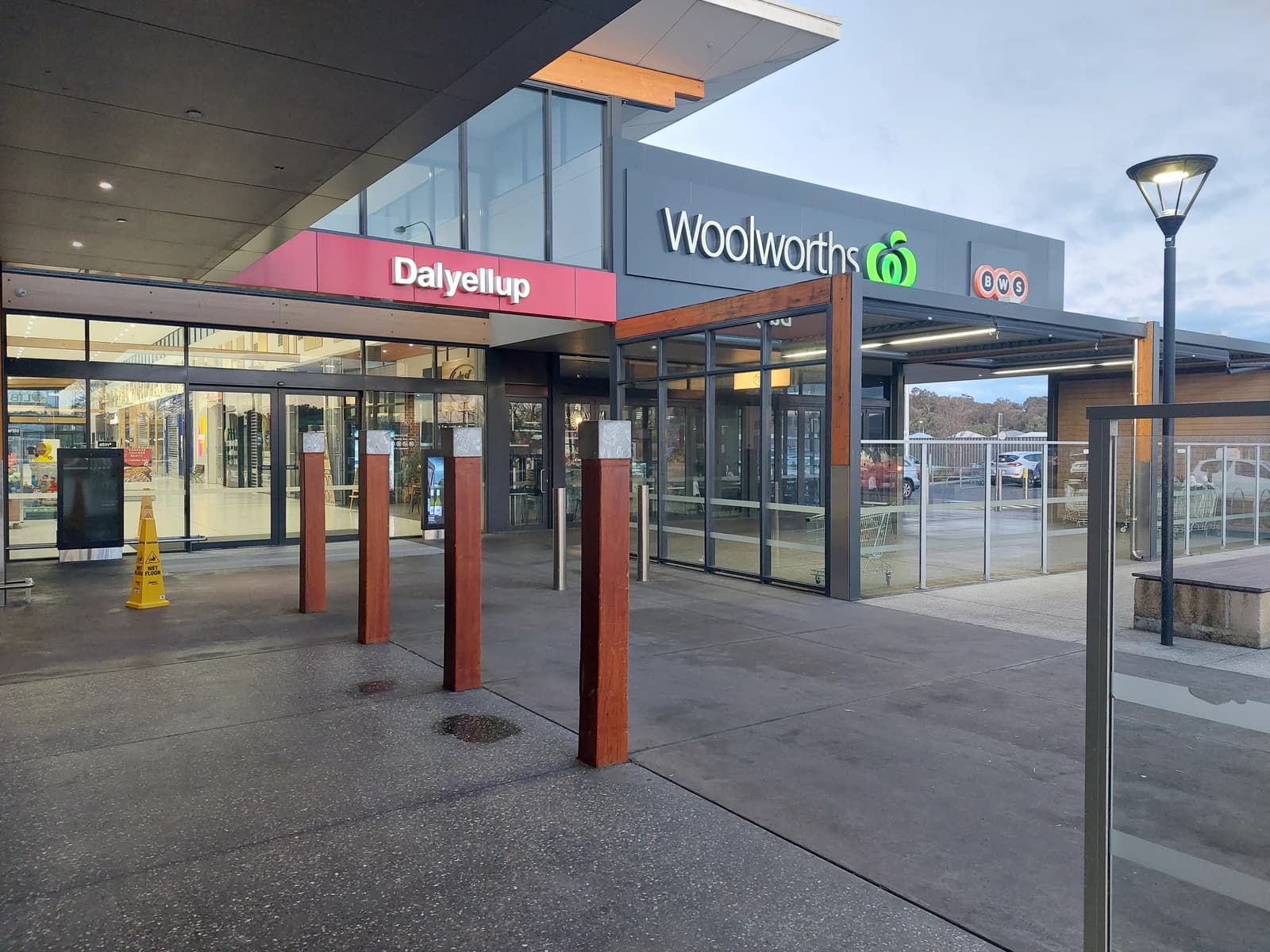 Exterior of a Woolworths supermarket building with a red Dalyellup sign.