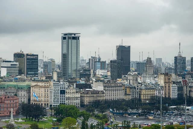 Buenos Aires city skyline with modern and historic buildings under cloudy skies.