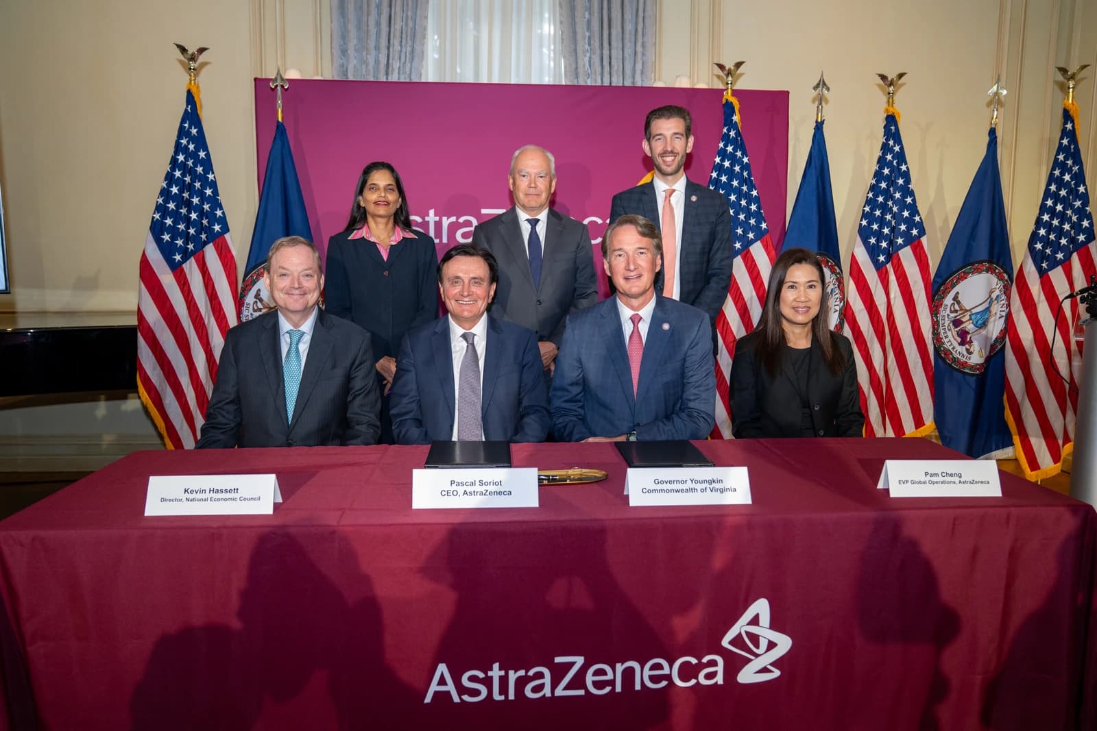 Pascal Soriot, CEO of AstraZeneca, seated at a table with other officials.