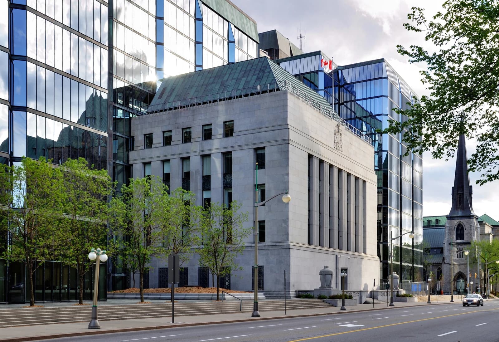 Exterior view of the Bank of Canada building in Ottawa on a cloudy day.