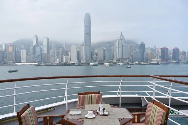 View of the Hong Kong skyline and Victoria Harbour from a cruise ship's deck.