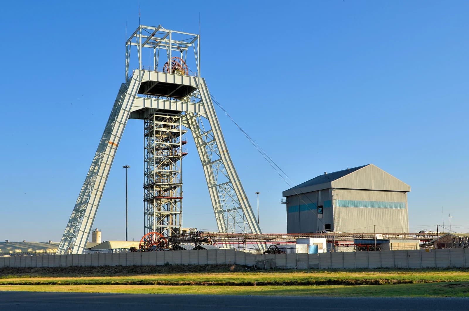 Shaft headframe at Tshepong South gold mine against a clear blue sky.