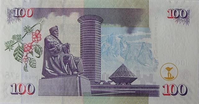 A detailed close-up of a Kenyan 100 Shilling banknote, featuring the image of Jomo Kenyatta.