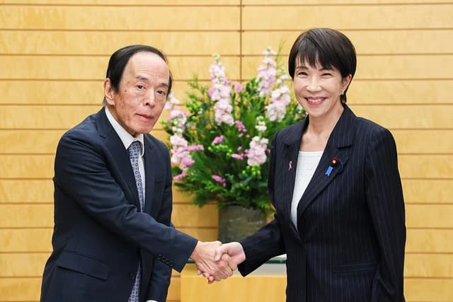 Sanae Takaichi and Bank of Japan Governor Kazuo Ueda shaking hands indoors.