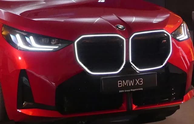 Close-up of the front fascia of a red BMW X3 car.