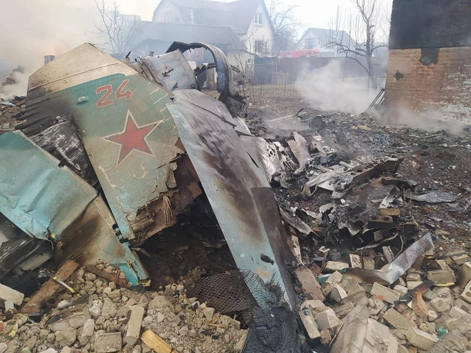 Debris from a downed Russian military aircraft with a red star insignia in Ukraine.
