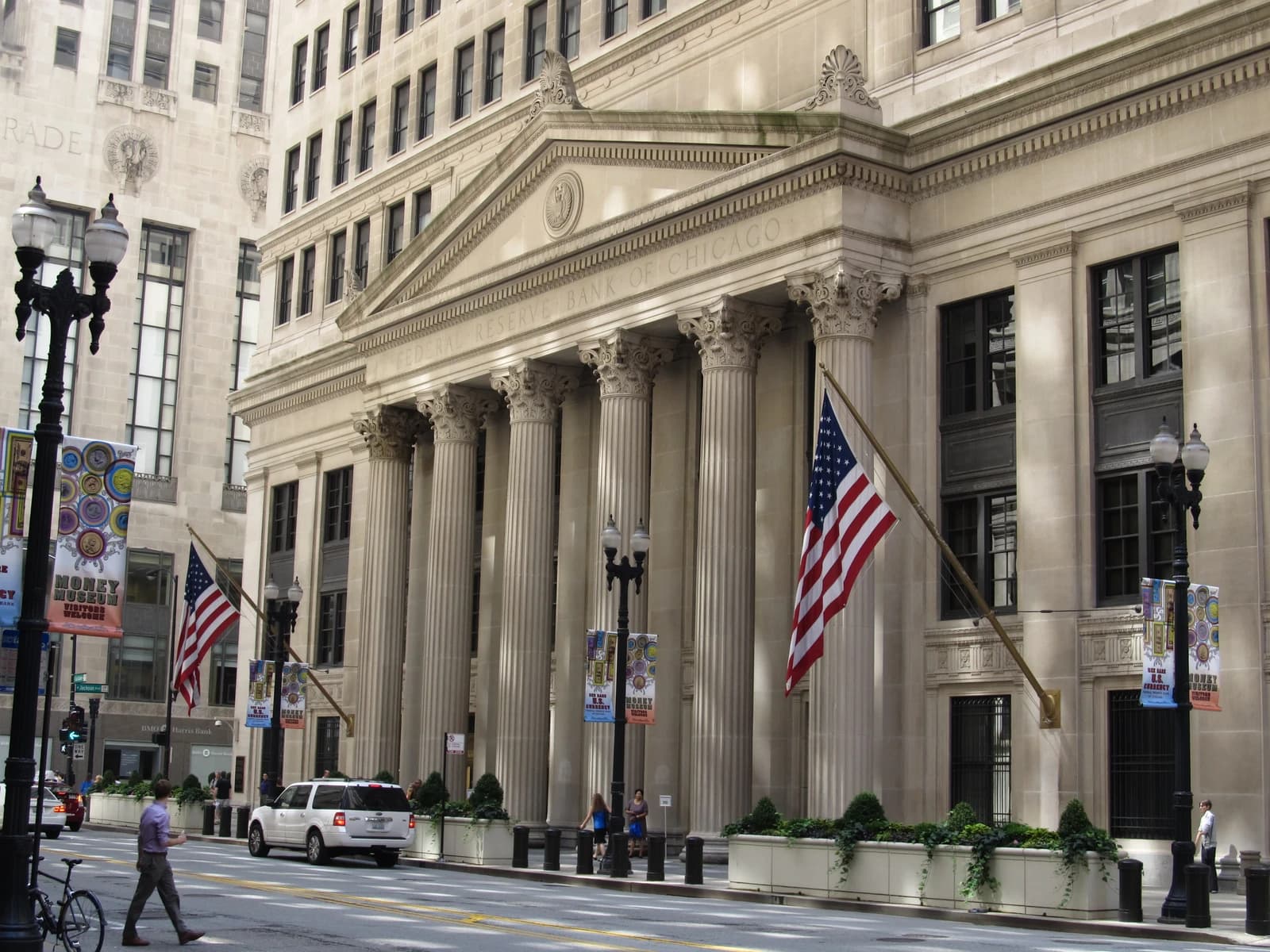 Federal Reserve Bank of Chicago building with columns and an American flag outside.
