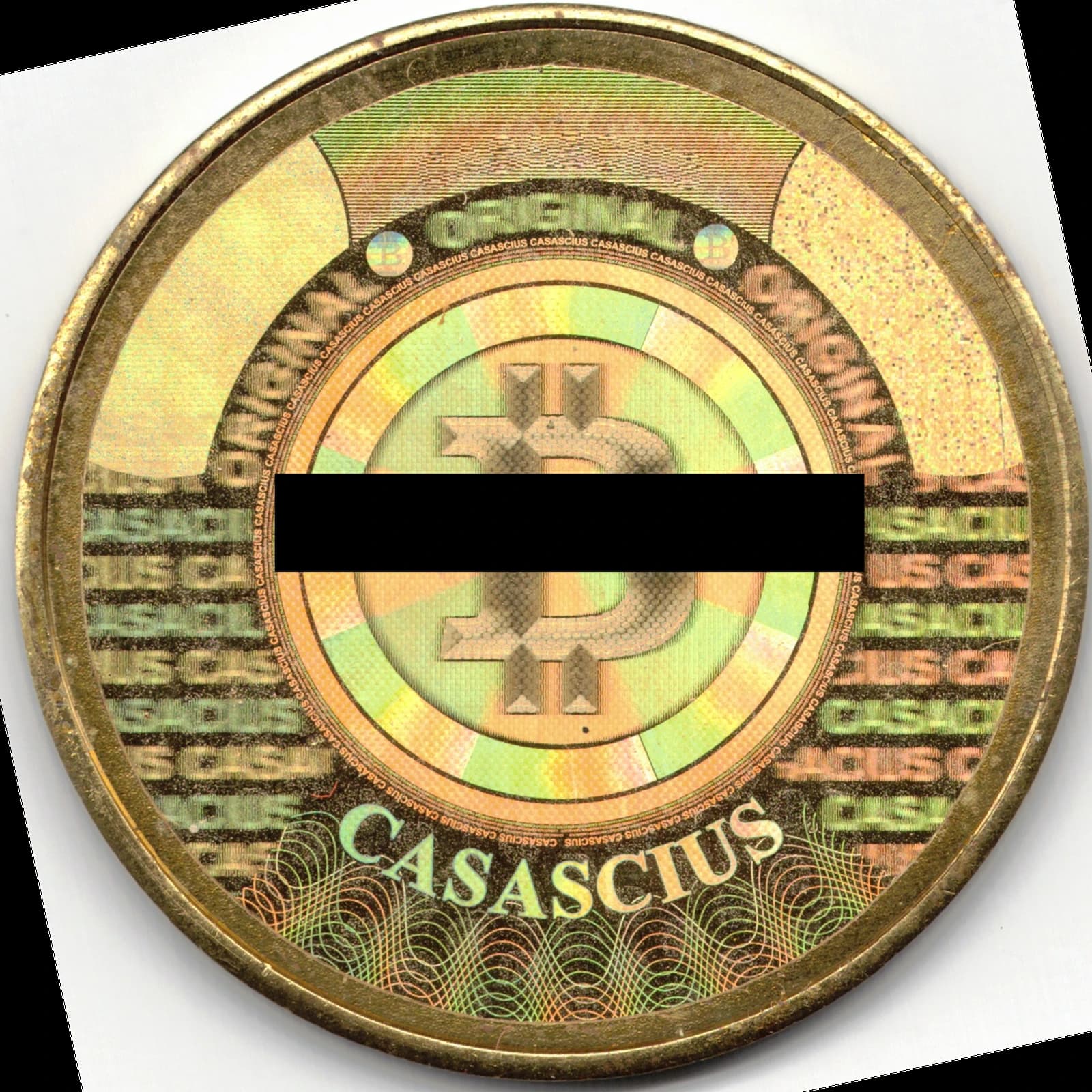 Physical Casascius Bitcoin token with a holographic sticker covering its center.