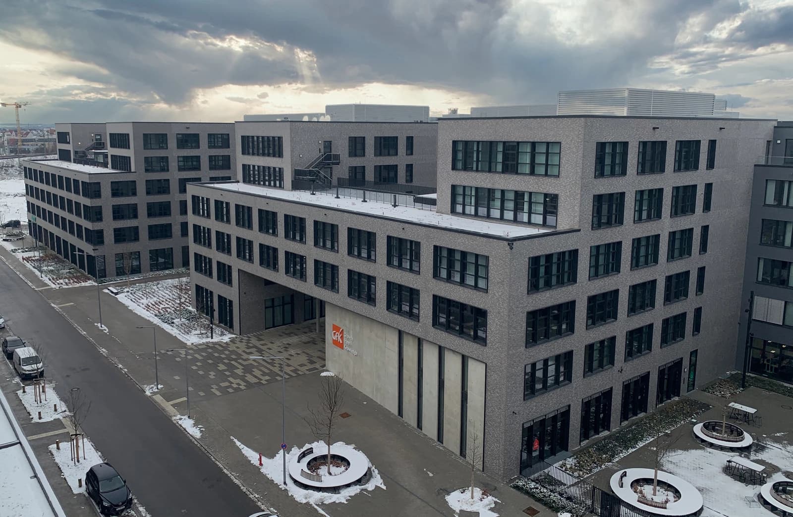 Exterior view of the GfK SE headquarters building during winter.