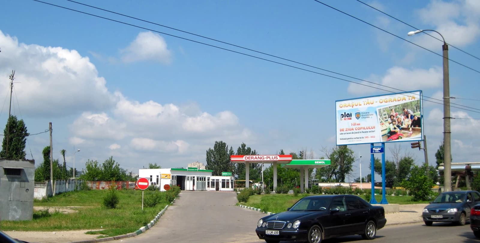 A gas station, visible from a street, under a clear sky in Moldova.