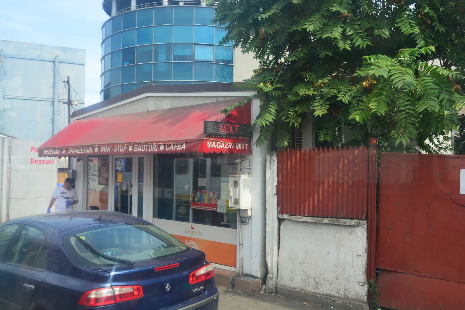 A blue car parked in front of Mini-Market Non-Stop on Strada Lizeanu, Bucharest.