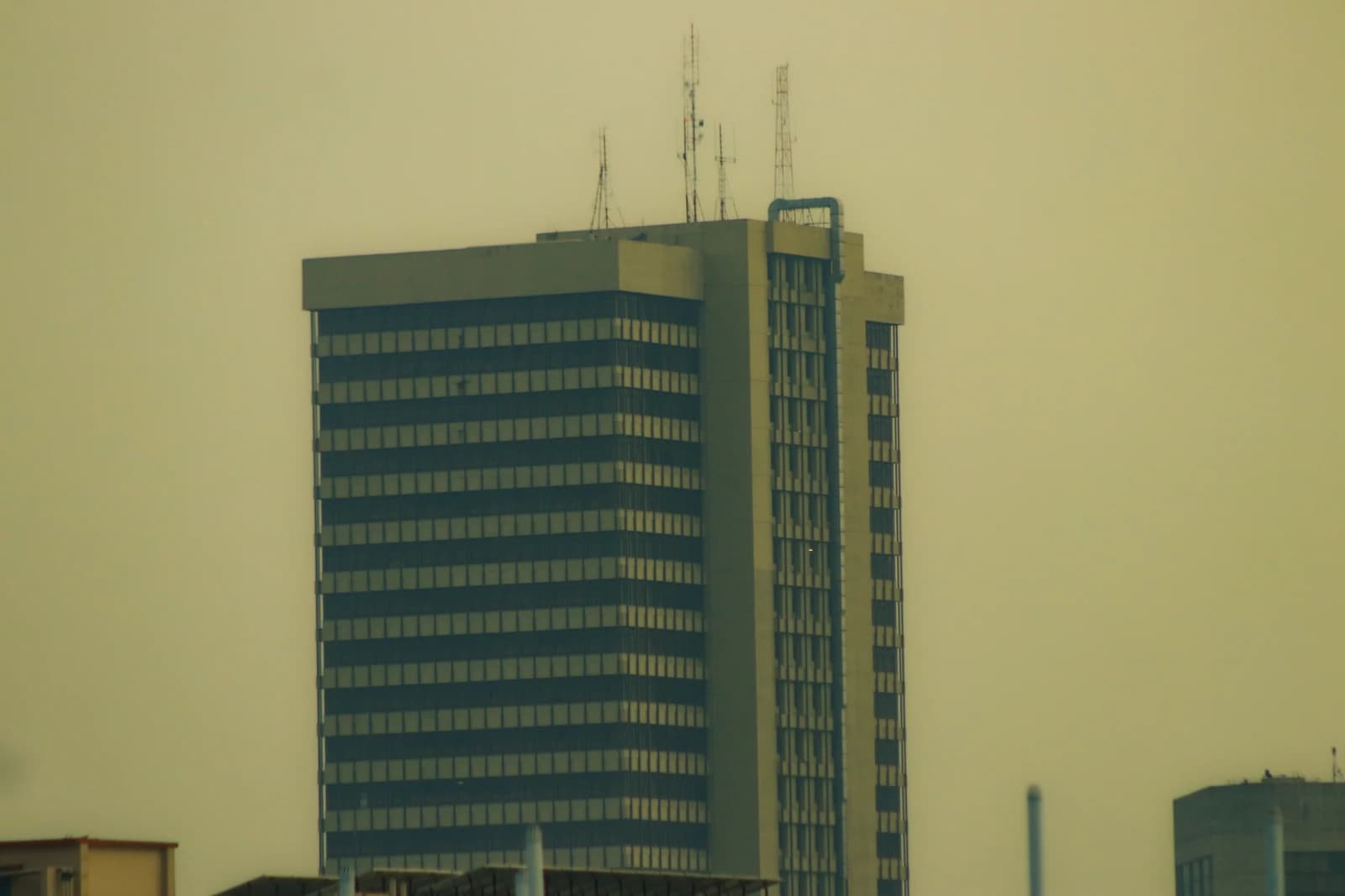 High-rise building of Bangladesh Bank in Motijheel, Dhaka under a light sky.