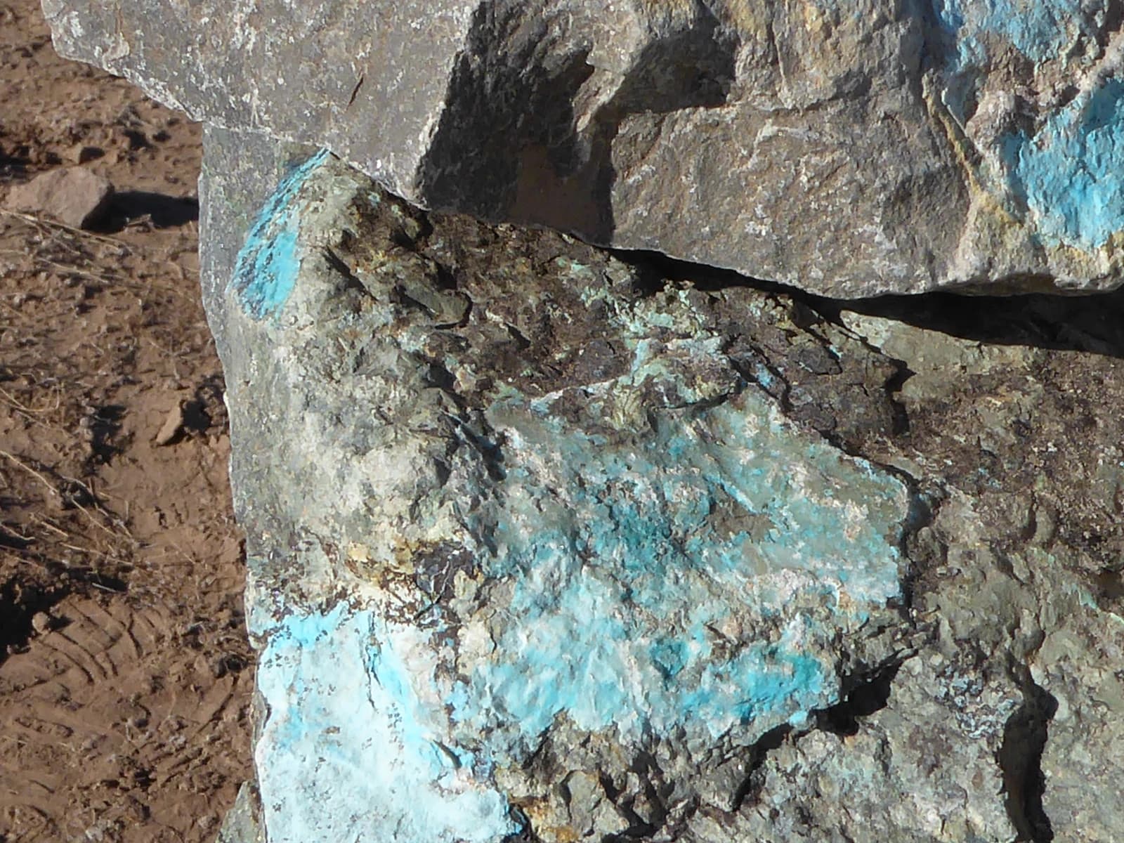 Close-up view of a rock containing visible blue-green copper ore minerals.