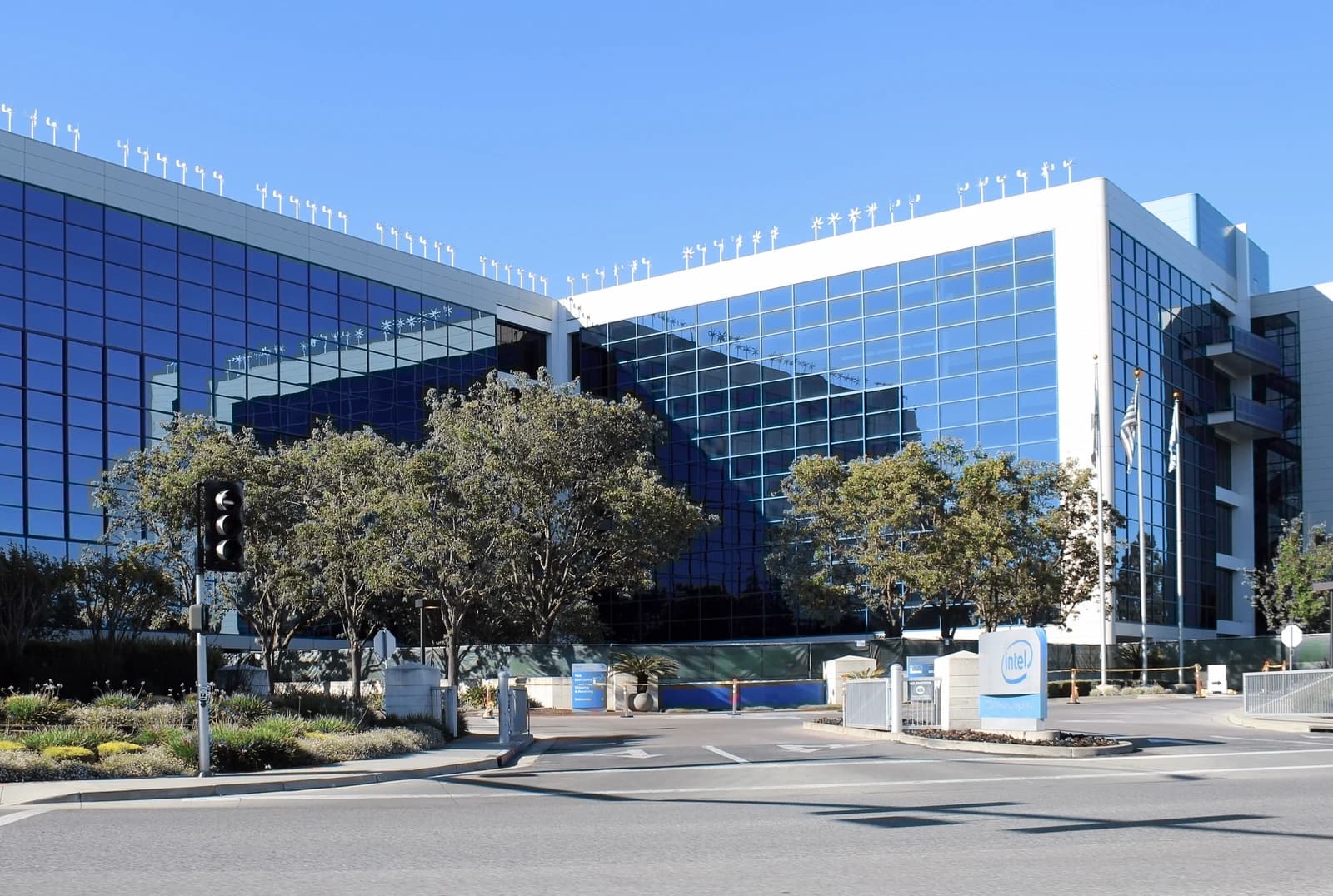 Intel corporate campus building with blue glass exterior and Intel logo sign.
