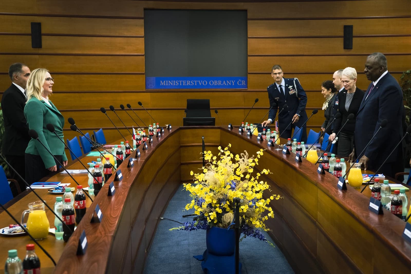 Alena Schillerová, Czech Minister of Finance, standing at a long conference table.