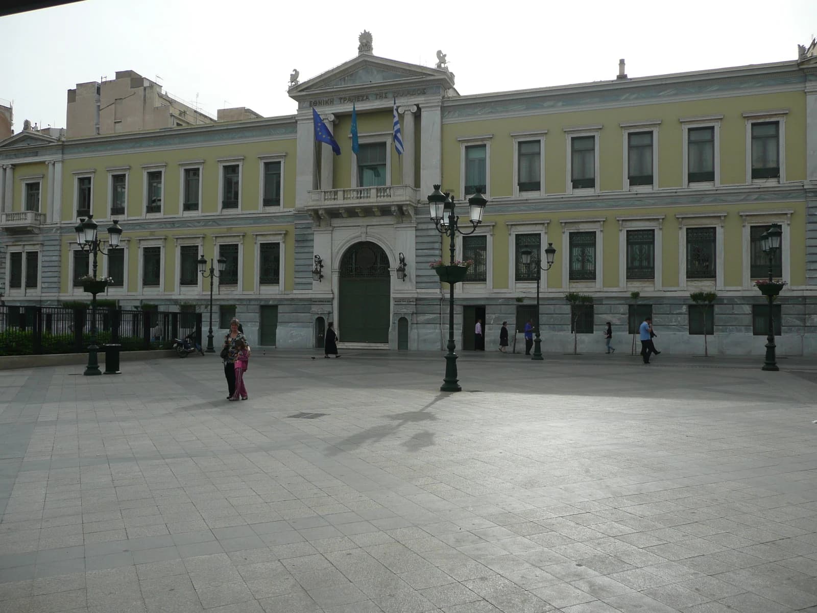 Exterior of the National Bank of Greece building on a city square in Athens.