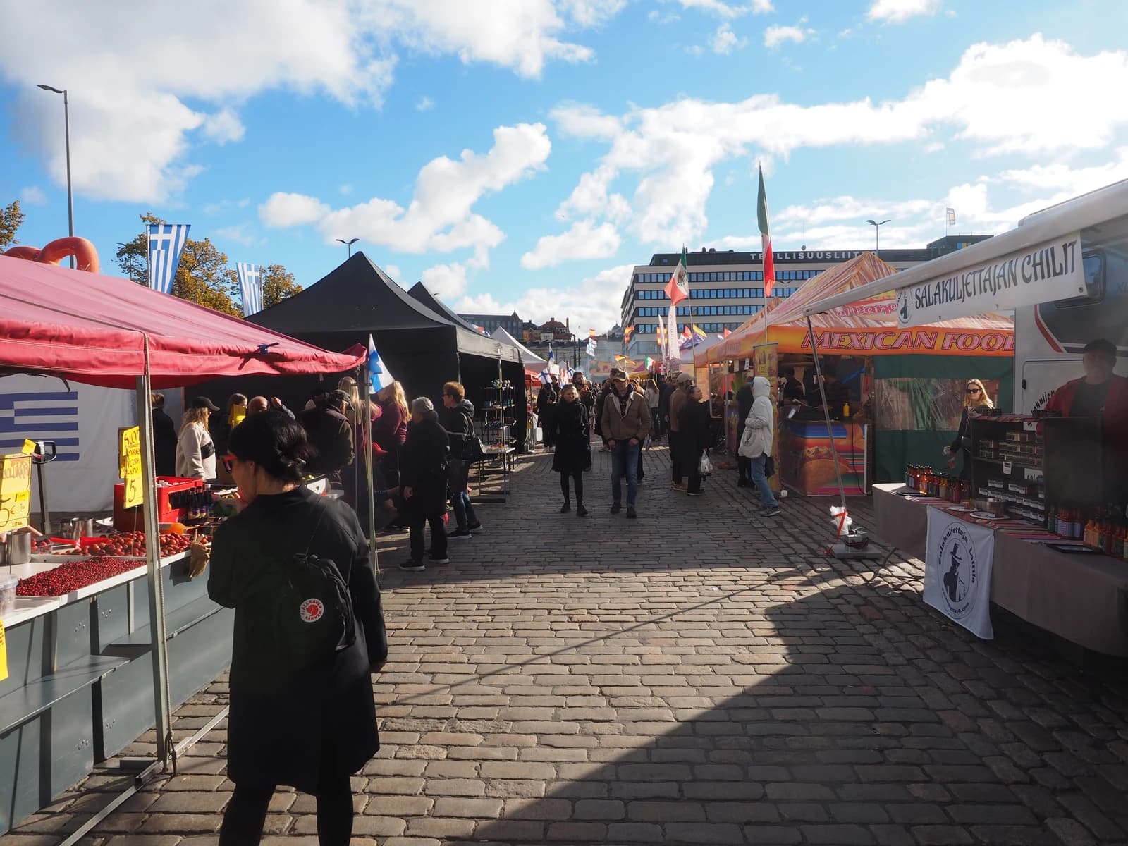 People browse food stalls at Hakaniemi Market Square in Helsinki, Finland.