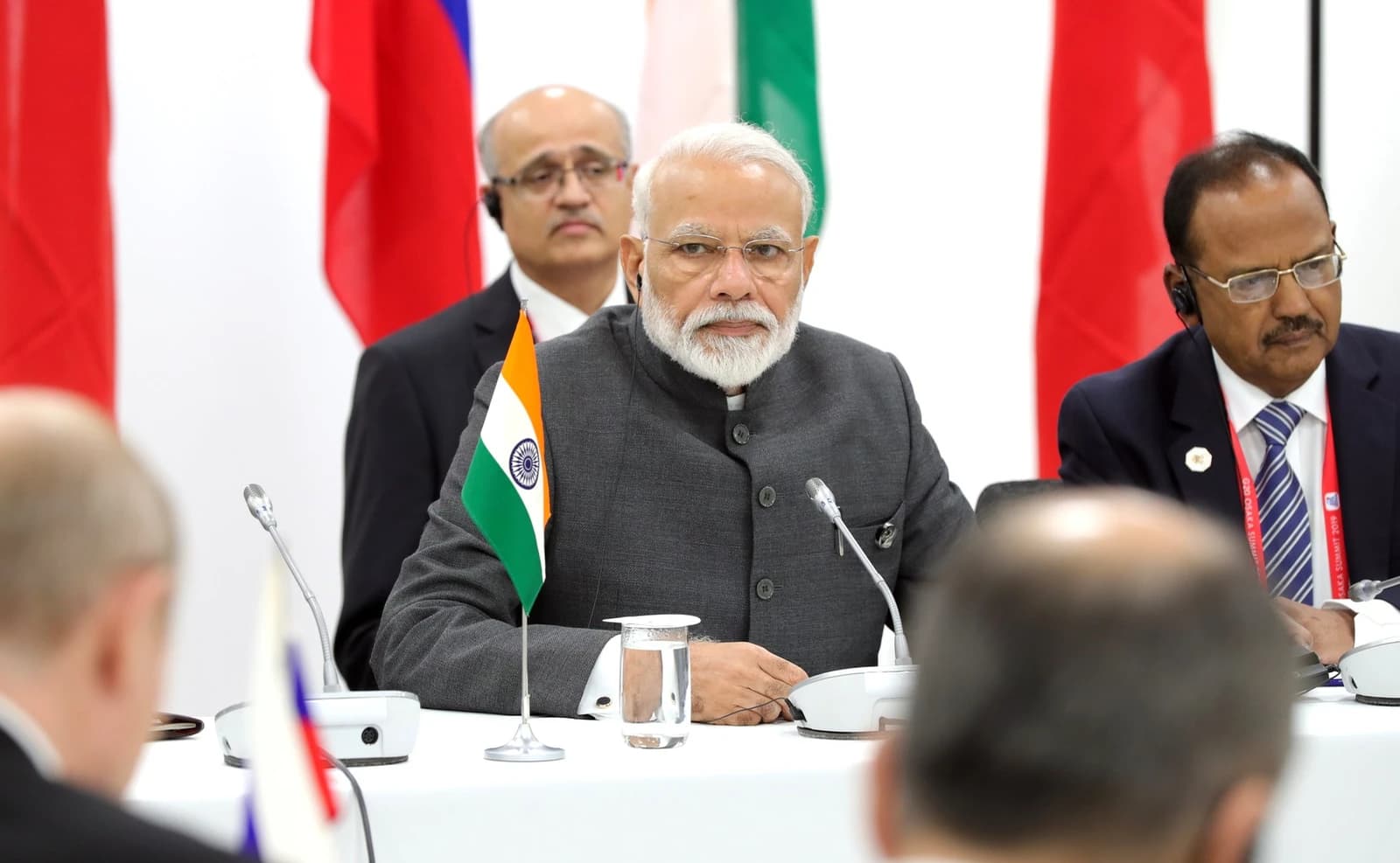 Narendra Modi, Prime Minister of India, seated at a meeting table during a summit.