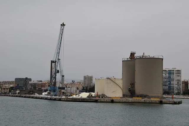 Silos and a crane at the Goliat Cement factory in the Port of Malaga.