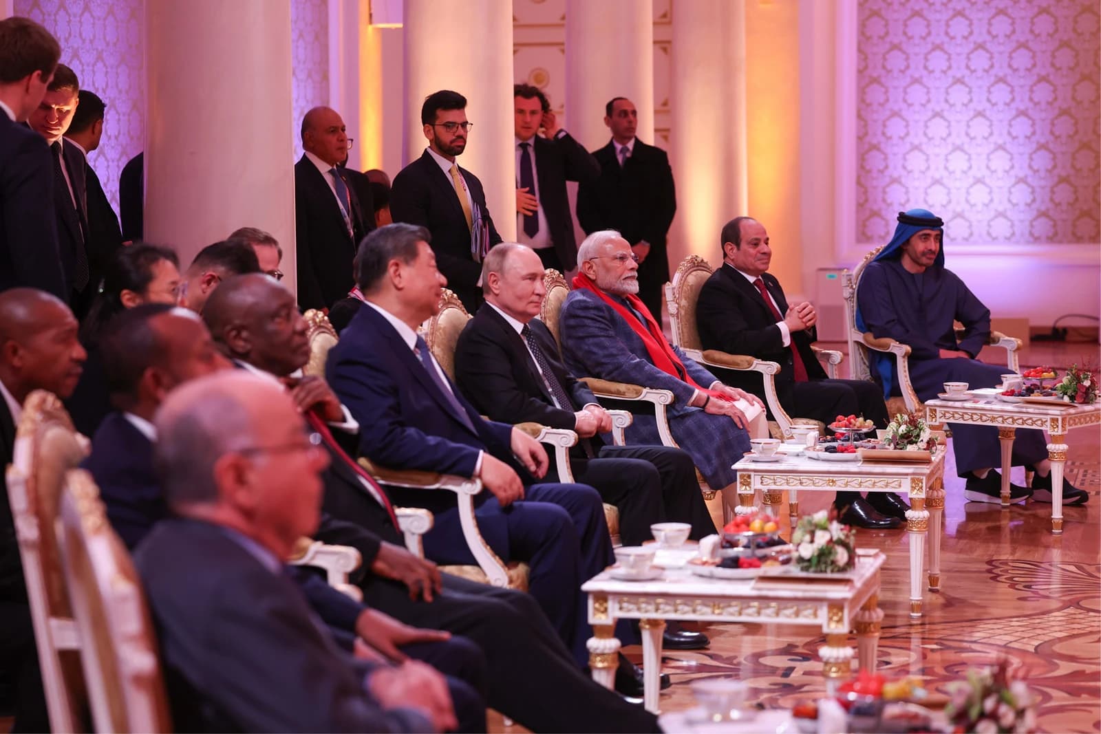Xi Jinping, Vladimir Putin, and Narendra Modi seated at a BRICS summit dinner.
