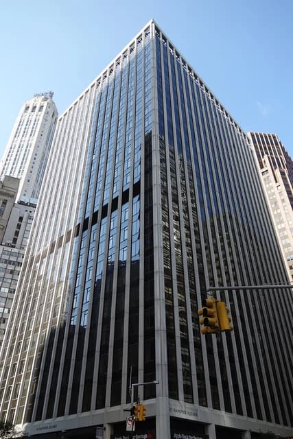 Exterior view of 10 Hanover Square, a tall building with many windows in New York City.