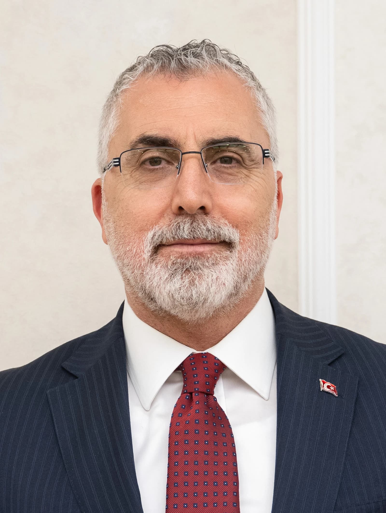 Vedat Işıkhan, Minister of Labour and Social Security, looking directly at the camera.