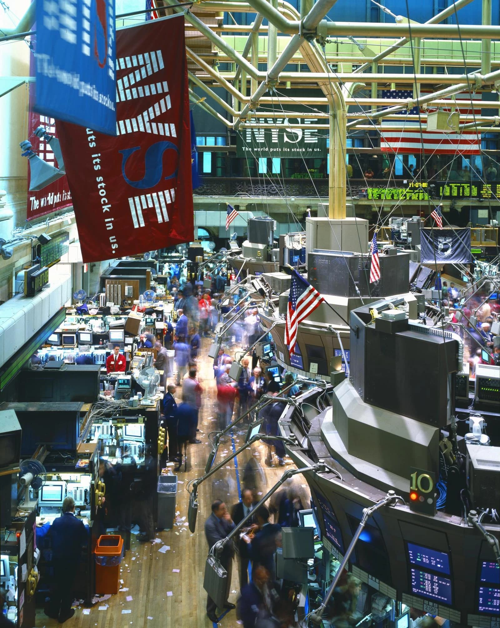 New York Stock Exchange trading floor showing brokers and digital displays.