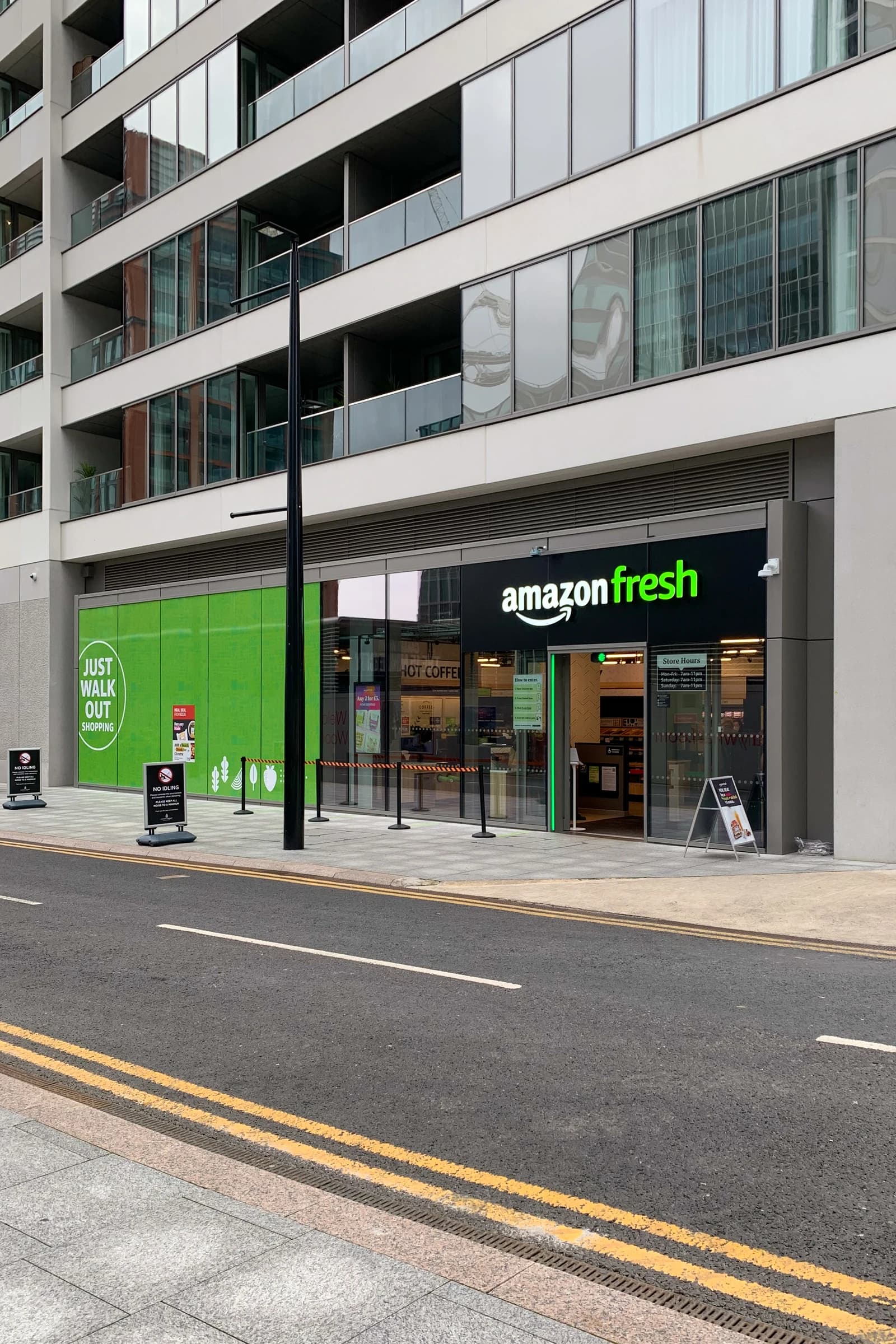Exterior view of an Amazon Fresh grocery store with its storefront and surrounding street.