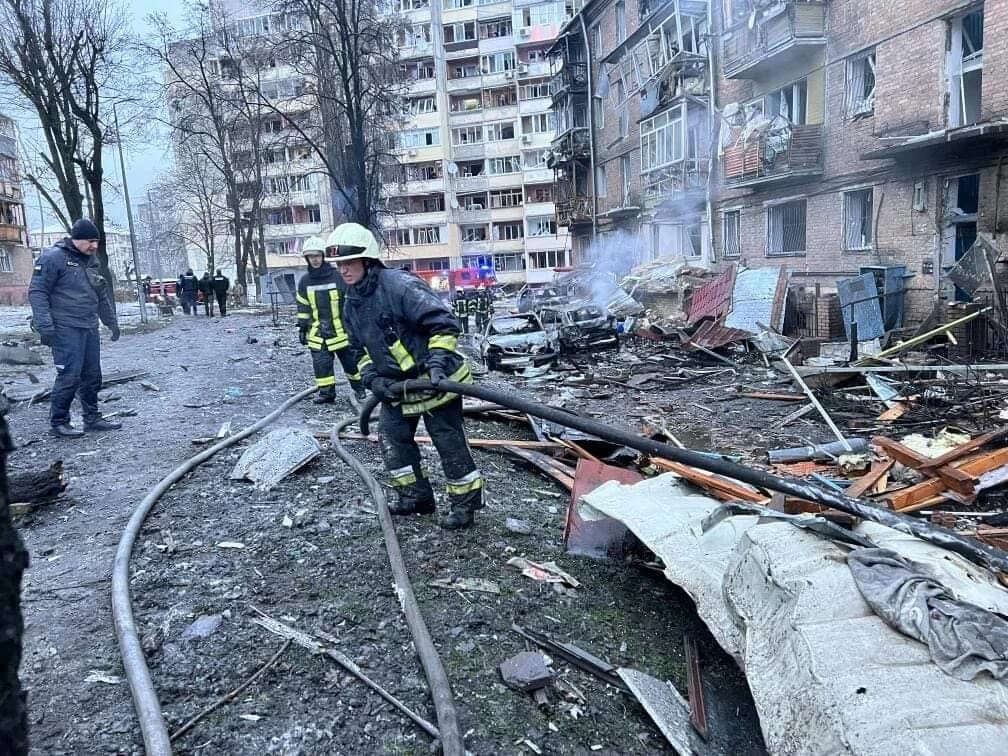 Emergency workers and debris in Vyshgorod after a Russian missile strike.