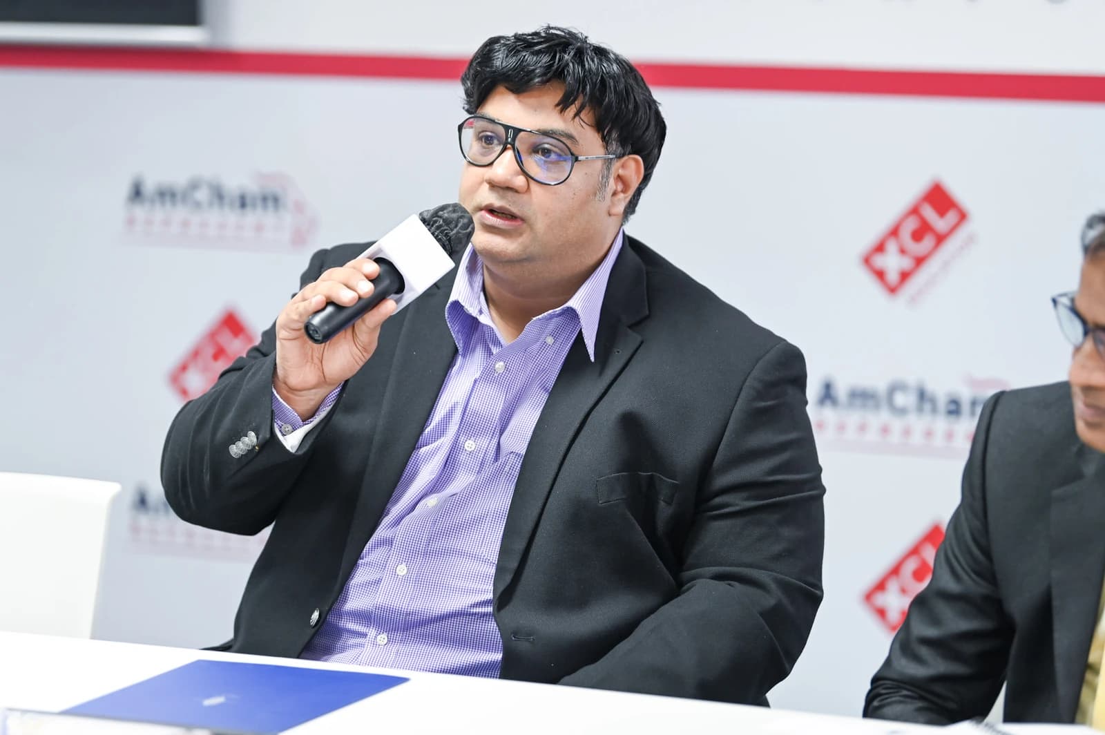 Siddhartha Paul Tiwari, speaker, addressing an audience with a microphone.