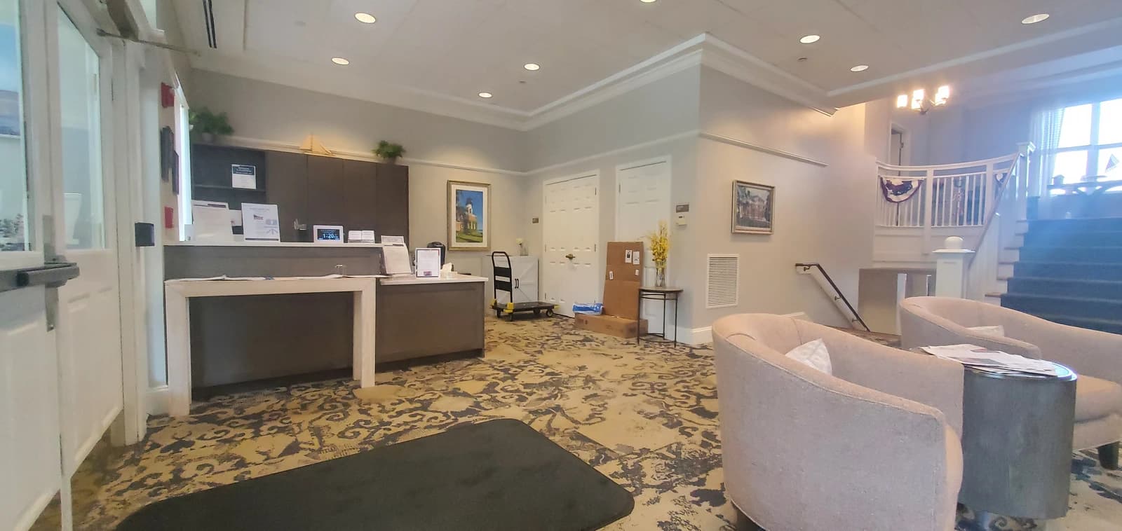 Lobby of Academy Point Assisted Living Facility with reception desk and seating area.