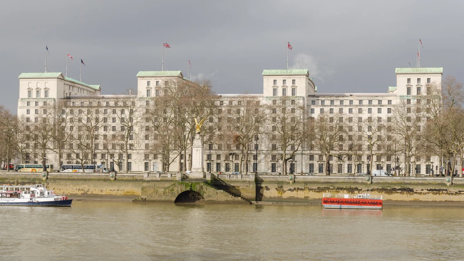 The Ministry of Defence Main Building in London with Union Jack flags flying.