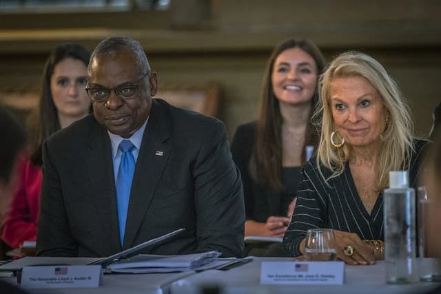 Lloyd J. Austin III and Caroline Kennedy at a table with name placards.