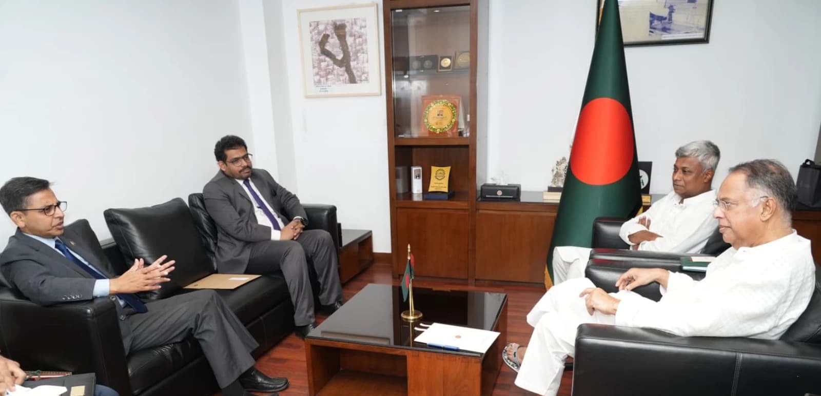 India High Commissioner Pranay Kumar Verma speaks with Bangladesh Energy Minister Iqbal Hasan Mahmud.