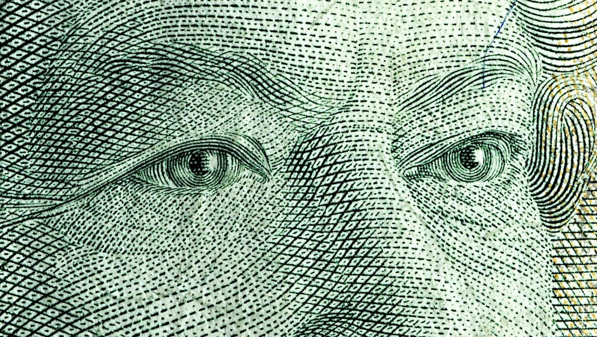 Close-up detail of Queen Elizabeth II's eyes on a Canadian twenty-dollar banknote.
