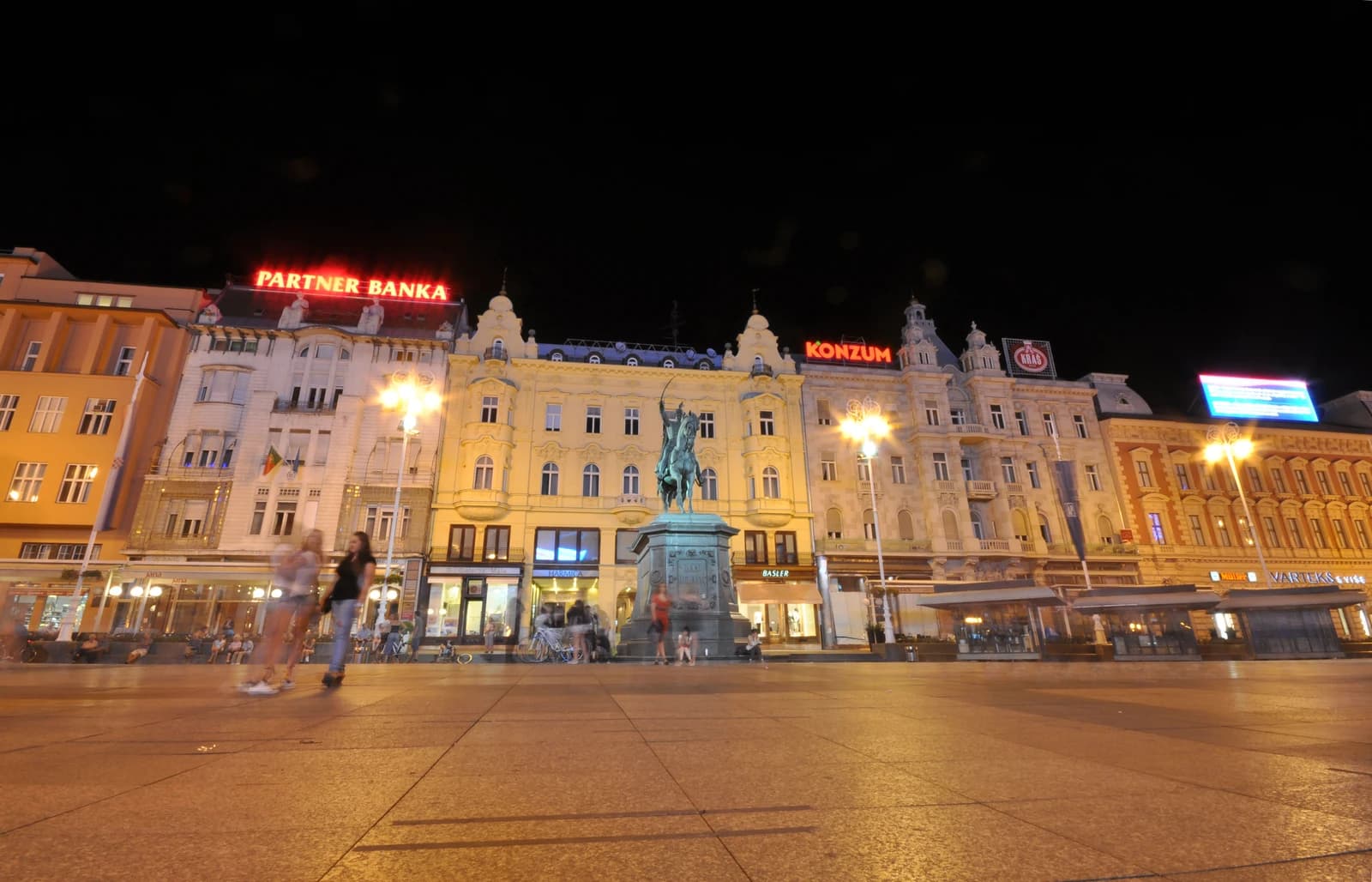 Buildings and a statue at Ban Jelačić Square in Zagreb, Croatia, at night.